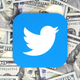 Twitter icon printed on paper and placed on money background.